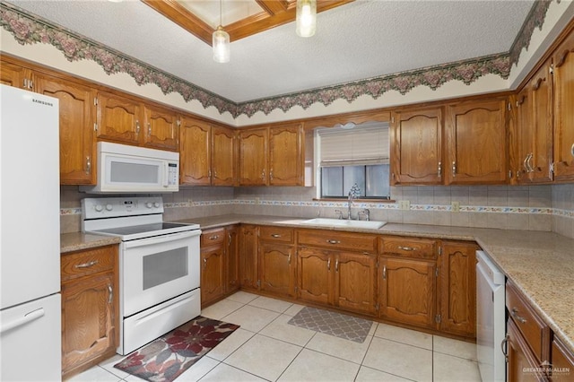 kitchen with light tile patterned floors, white appliances, tasteful backsplash, and sink