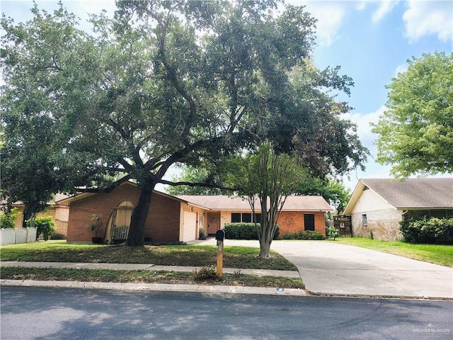 6213 N 17th St, Mcallen, TX 78504 - view of front of home featuring driveway, a garage, and brick siding