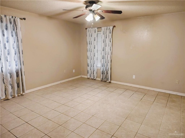 6213 N 17th St, Mcallen, TX 78504 - empty room with a ceiling fan, a textured ceiling, light tile patterned floors, and baseboards