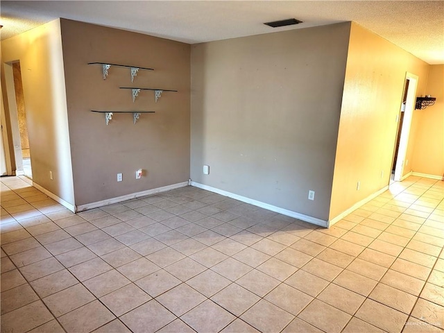 6213 N 17th St, Mcallen, TX 78504 - empty room with light tile patterned floors and a textured ceiling