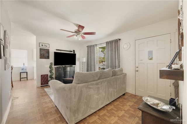 living room with light parquet flooring and ceiling fan