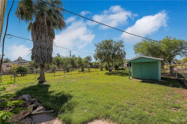 view of yard with a rural view and a storage unit