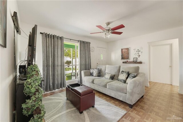 living room featuring ceiling fan and light parquet flooring