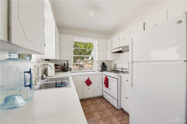 kitchen featuring sink, white cabinets, dark parquet floors, and white appliances