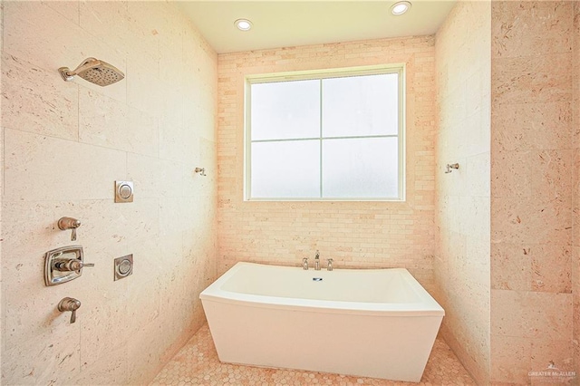 4835 Bryan Rd, Palmhurst, TX 78573 - bathroom featuring a freestanding tub, tile walls, and tile patterned floors