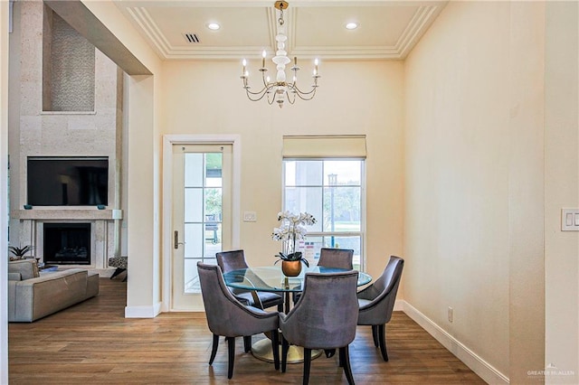 4835 Bryan Rd, Palmhurst, TX 78573 - dining area with a chandelier, crown molding, a fireplace, wood finished floors, and beamed ceiling