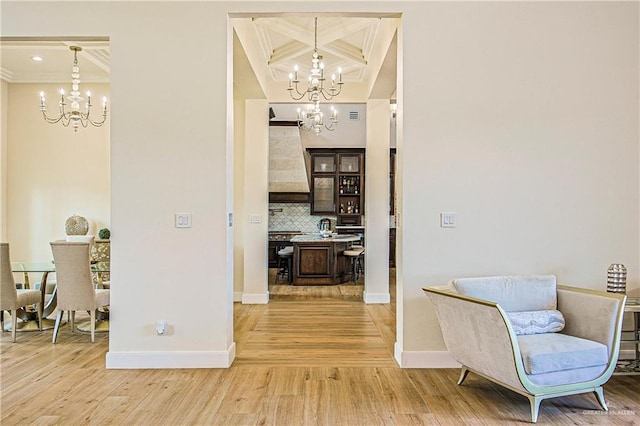 4835 Bryan Rd, Palmhurst, TX 78573 - hallway featuring a chandelier, light wood finished floors, ornamental molding, coffered ceiling, and beam ceiling