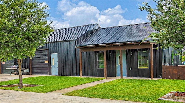 4835 Bryan Rd, Palmhurst, TX 78573 - view of front of house with a front yard, a metal roof, a garage, and driveway