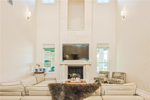 4835 Bryan Rd, Palmhurst, TX 78573 - living area featuring a towering ceiling, a premium fireplace, and plenty of natural light