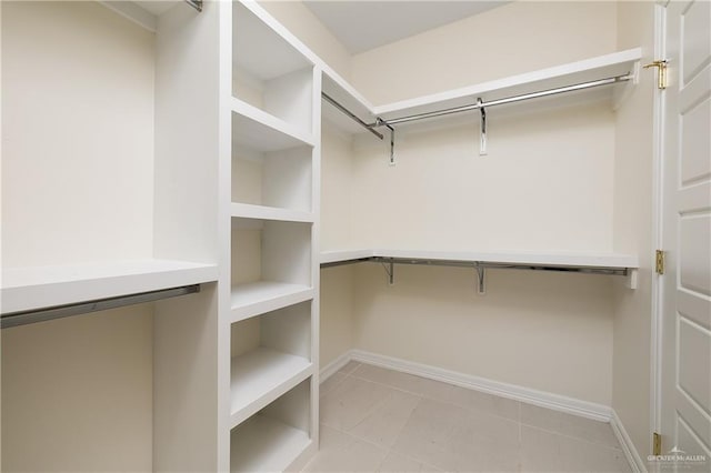 walk in closet featuring light tile patterned flooring