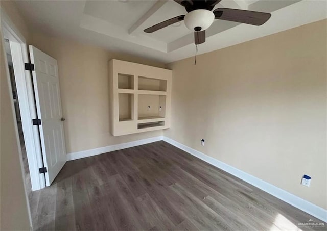 2505 W Bella Vista Ave W, Alton, TX 78573 - spare room featuring a tray ceiling, dark wood-style floors, and baseboards