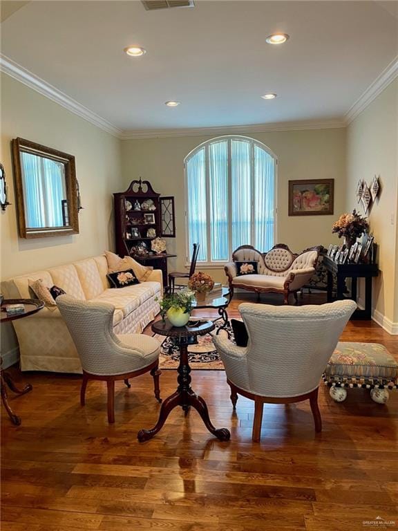 living room featuring hardwood / wood-style flooring and ornamental molding