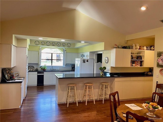 kitchen featuring white refrigerator, white cabinets, and kitchen peninsula