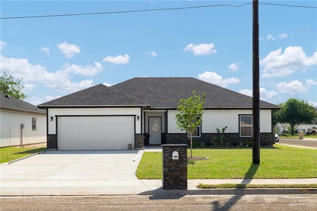 view of front facade featuring driveway, stone siding, an attached garage, a front yard, and roof with shingles