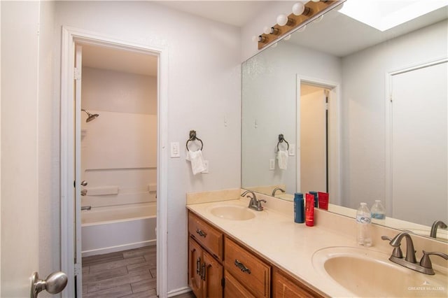 bathroom with bathtub / shower combination, vanity, and wood-type flooring