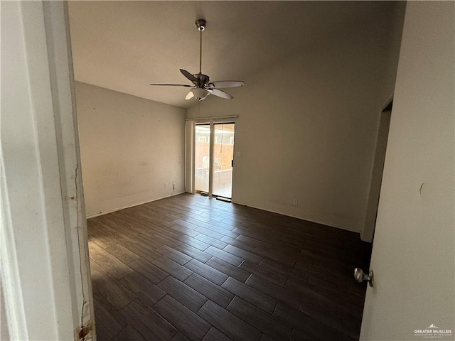 spare room featuring ceiling fan, dark hardwood / wood-style flooring, and vaulted ceiling