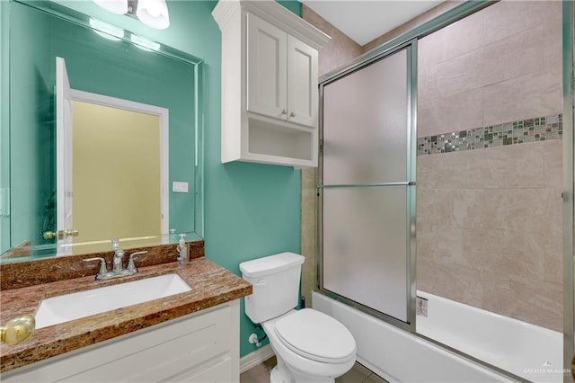 full bathroom with vanity, toilet, and bath / shower combo with glass door