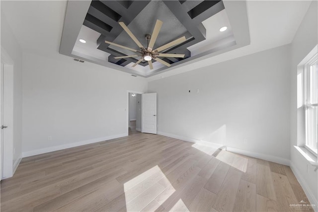 1405 Helen Dr, Weslaco, TX 78599 - unfurnished bedroom with a tray ceiling, light wood-type flooring, recessed lighting, baseboards, and ceiling fan