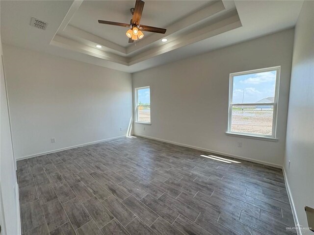 spare room featuring a raised ceiling