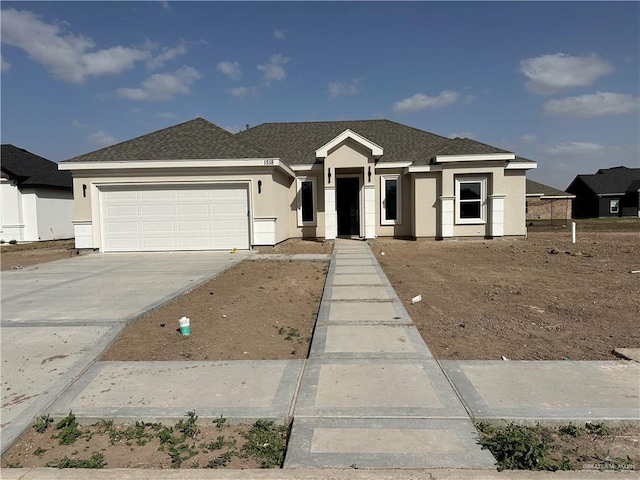 view of front facade featuring a garage, roof with shingles, driveway, and stucco siding