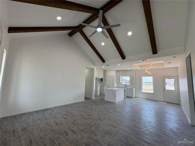 unfurnished living room with high vaulted ceiling