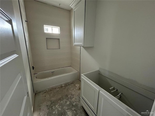 bathroom with tiled shower / bath and concrete floors