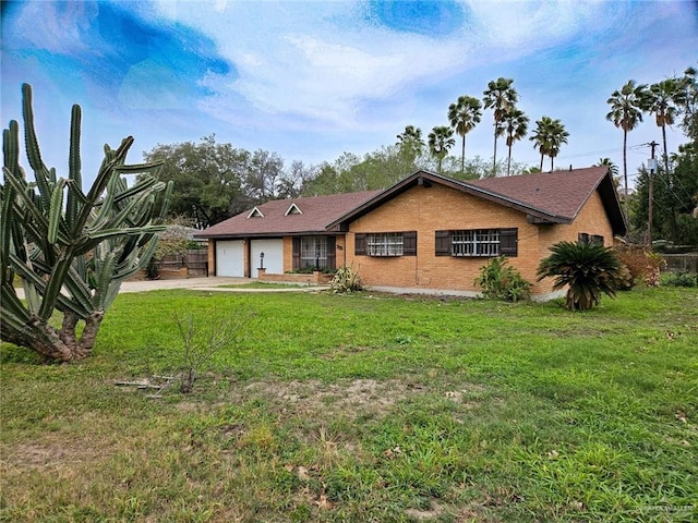 905 E Ithaca Ave, Mcallen, TX 78501 - rear view of house with a yard, a garage, driveway, and brick siding
