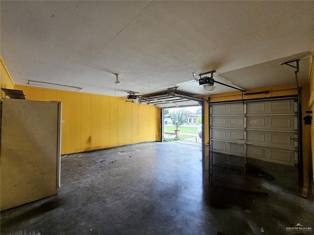 905 E Ithaca Ave, Mcallen, TX 78501 - garage featuring freestanding refrigerator and a garage door opener