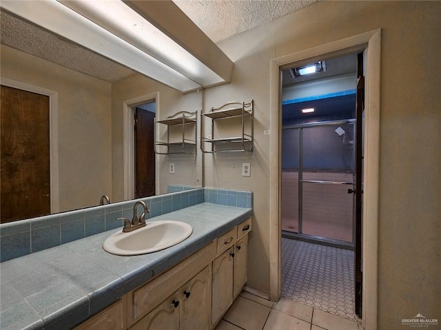 905 E Ithaca Ave, Mcallen, TX 78501 - bathroom with a textured ceiling, tile patterned floors, and vanity