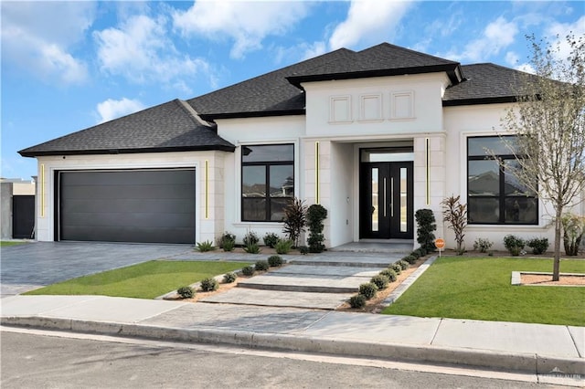 view of front of house featuring stucco siding, driveway, roof with shingles, a front yard, and a garage