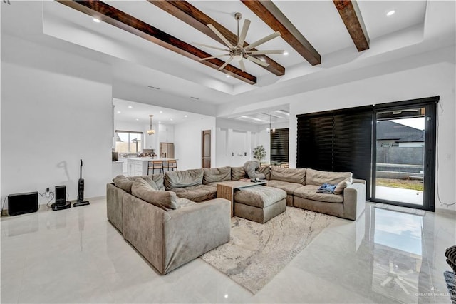 living area featuring recessed lighting, a tray ceiling, beam ceiling, and ceiling fan