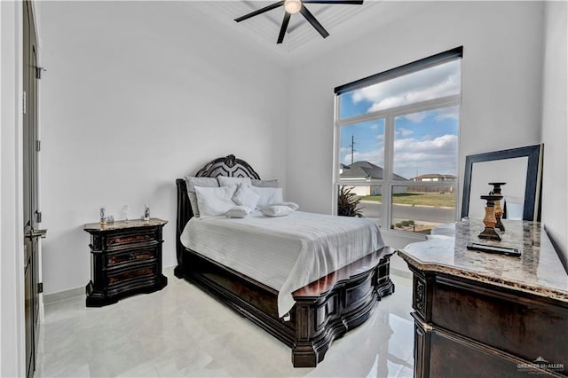 bedroom with ceiling fan and baseboards