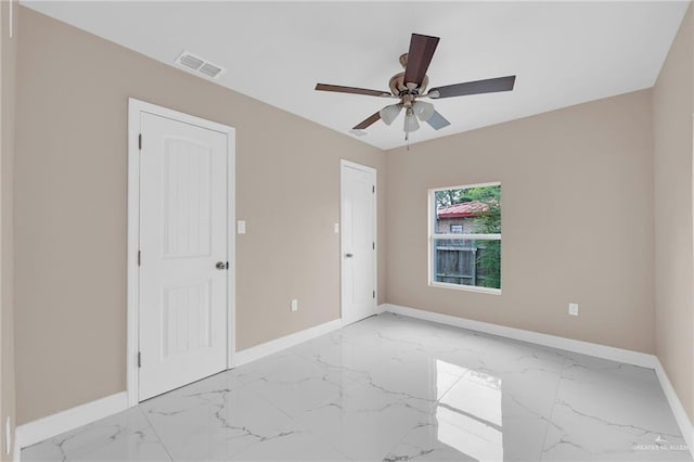 410 W 7th St, San Juan, TX 78589 - unfurnished bedroom featuring marble look tile flooring and ceiling fan