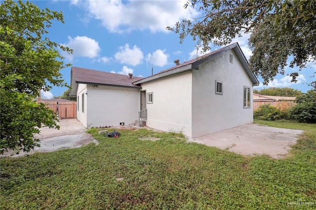410 W 7th St, San Juan, TX 78589 - back of property with a patio area and stucco siding