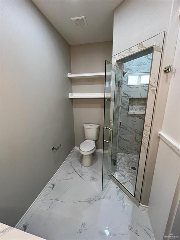 bathroom with toilet and a shower with door