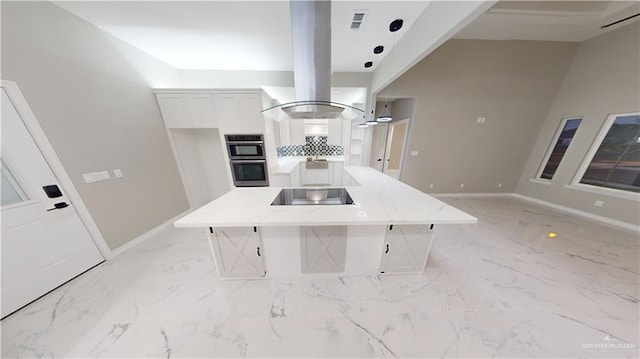 kitchen with a kitchen island with sink, island range hood, white cabinets, and black electric cooktop