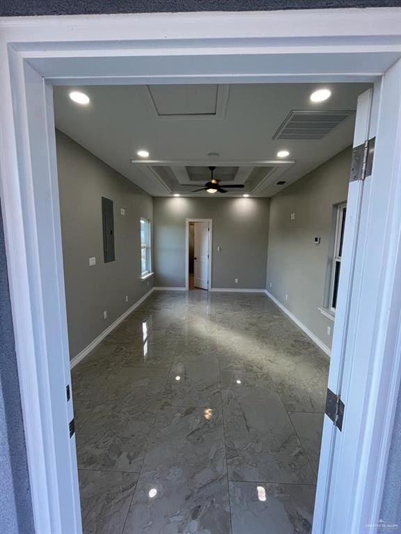 unfurnished room featuring ceiling fan and electric panel