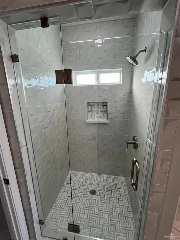 bathroom featuring a shower with shower door