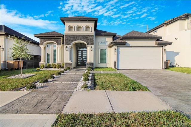 view of front facade featuring a garage, a front yard, and french doors