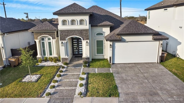 view of front facade featuring french doors, a garage, and a front yard