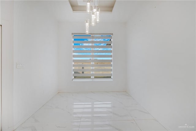 spare room featuring a tray ceiling