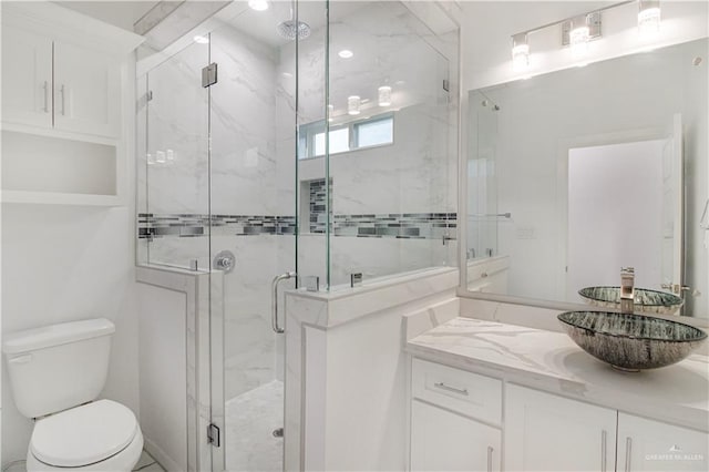 bathroom featuring vanity, toilet, and walk in shower