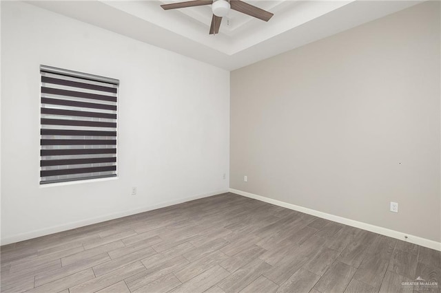 907 W Carmel Ave, Pharr, TX 78577 - empty room with ceiling fan, wood finished floors, a tray ceiling, and baseboards