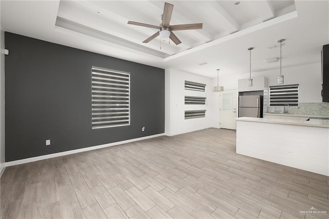 907 W Carmel Ave, Pharr, TX 78577 - unfurnished living room featuring a ceiling fan, light wood-style flooring, and baseboards