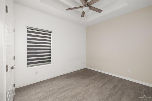 907 W Carmel Ave, Pharr, TX 78577 - spare room featuring wood finished floors, ceiling fan, a raised ceiling, and baseboards