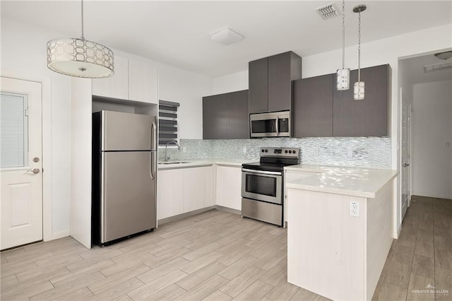 907 W Carmel Ave, Pharr, TX 78577 - kitchen with stainless steel appliances, light countertops, and light wood finished floors