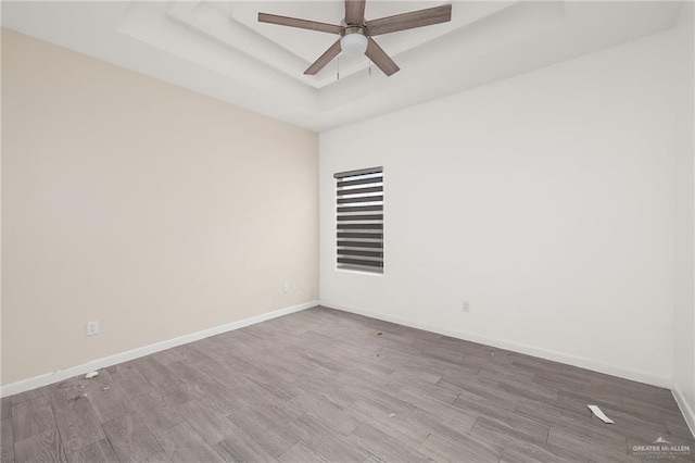 907 W Carmel Ave, Pharr, TX 78577 - spare room featuring a raised ceiling, ceiling fan, wood finished floors, and baseboards