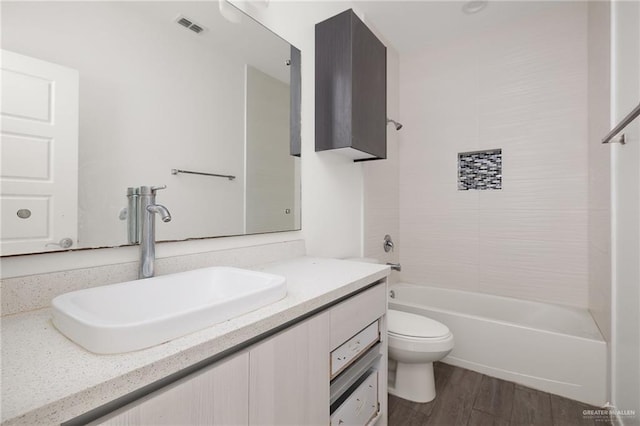 907 W Carmel Ave, Pharr, TX 78577 - full bath featuring vanity, toilet, shower / washtub combination, and wood finished floors