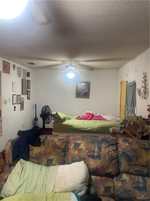 bedroom featuring ceiling fan and a textured ceiling