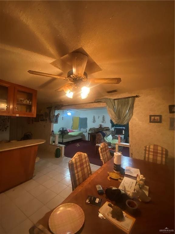 dining room with ceiling fan and light tile patterned floors